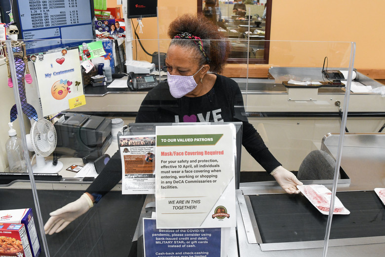 Store clerk Wynetta Johnson scans a customer's purchases. Plexiglass, seen here, is just one of the tools recommended by Barbara Weltman for use in a Covid-19 economy. (Credit: Jill Pickett, U.S. Air Force)