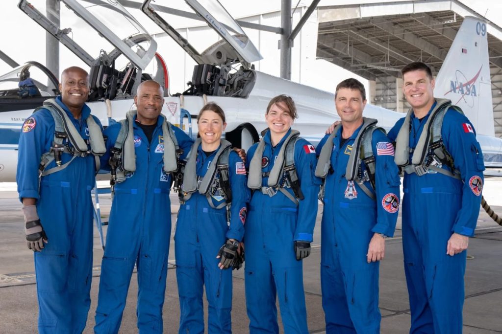The Artemis II crew (with Christina Koch third astronaut from left) pose before they take off for their mission around the moon. The crew includes two backup members. (Credit: NASA)