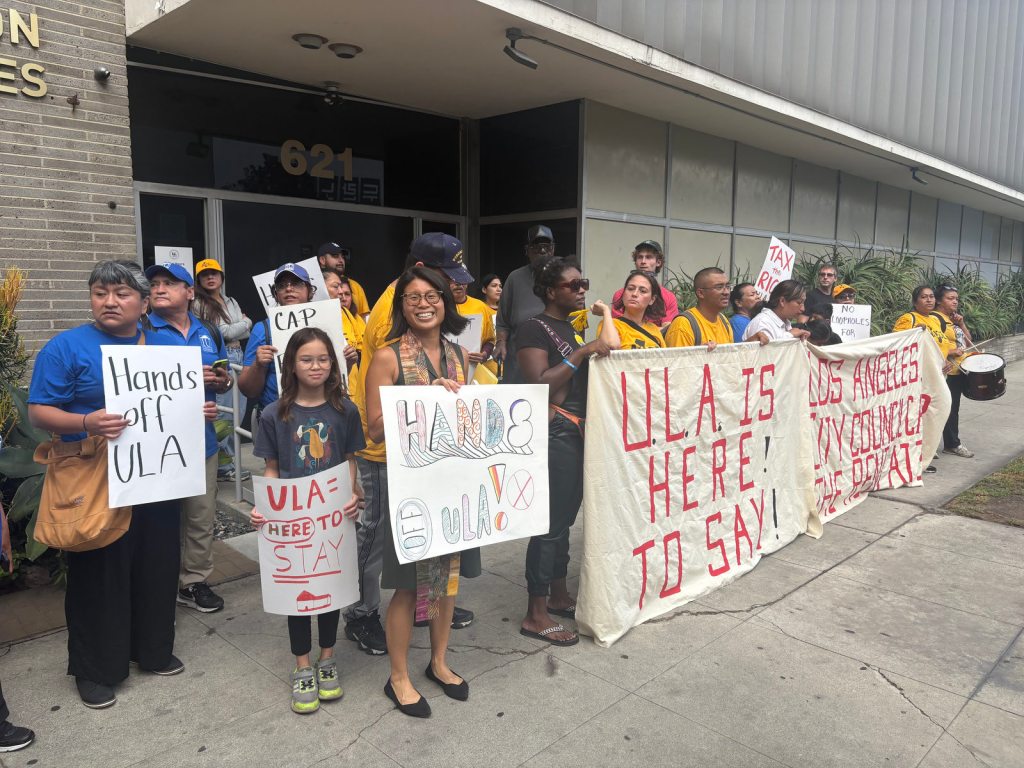 People in a group holding signs.