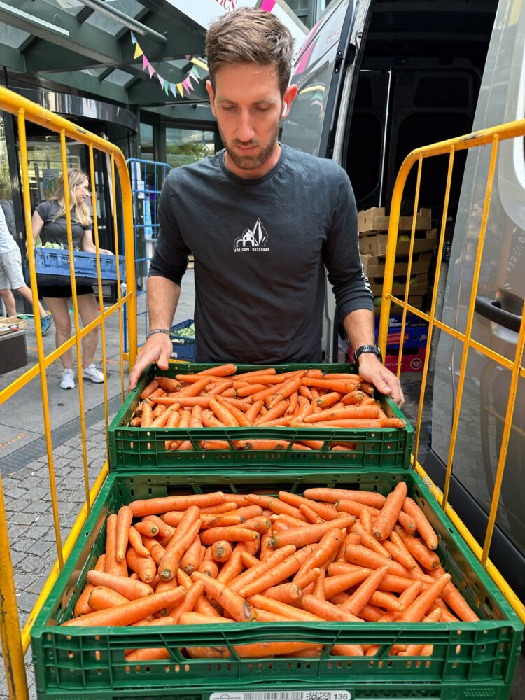The team unloads produce from the rescue van. (Credit: Hannah Hall)